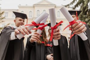 young-students-holding-diploma-e1607504563642